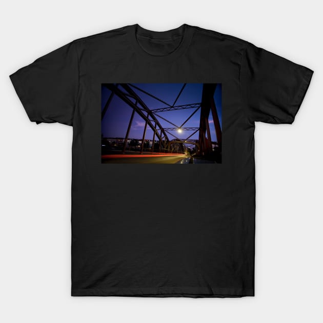 Perspective of an iron bridge with car light trails at twilight in Berlin, Germany T-Shirt by Reinvention